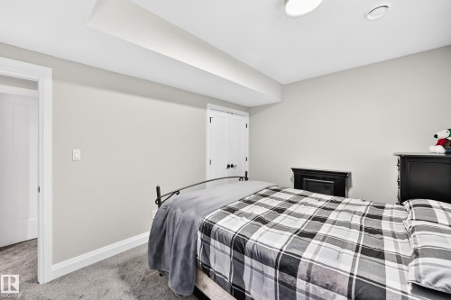 Bedroom featuring light gray wall paint, gray carpeting, a white baseboard trim, a white interior door, and a recessed ceiling light - 12631 52 Avenue, Edmonton, AB 