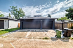 Detached two-car garage with contemporary dark gray doors and exterior - 