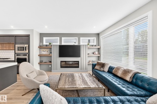 Spacious living area featuring light wood-finish flooring and recessed lighting - 12631 52 Avenue, Edmonton, AB 