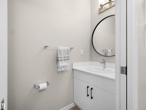 Contemporary bathroom vanity featuring a white countertop, undermount sink, and matte black hardware - 49 17832 78 Street, Edmonton, AB 