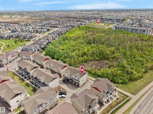 Aerial perspective showcasing a residential development with multi-story townhomes and single-family residences - 49 17832 78 Street, Edmonton, AB 