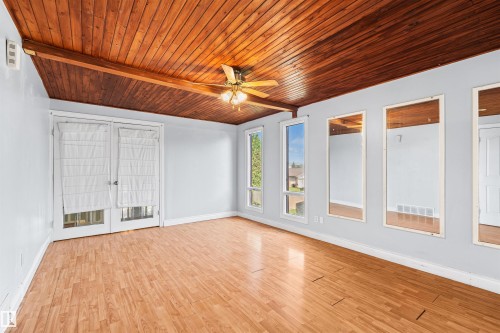 Vaulted wood-plank ceiling with exposed beam and ceiling fan - 11507 141 Avenue Nw, Edmonton, AB - Indoor Photo Showing Other Room