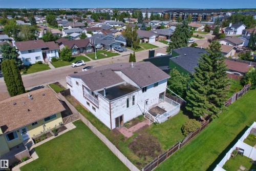Rear exterior featuring a ground-level deck, upper-level balcony, and fenced yard space - 11507 141 Avenue Nw, Edmonton, AB - Outdoor With View