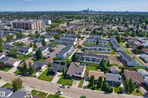 Residential property featuring a two-story structure with an attached garage, a paved driveway, and mature landscaping - 11507 141 Avenue Nw, Edmonton, AB - Outdoor With View