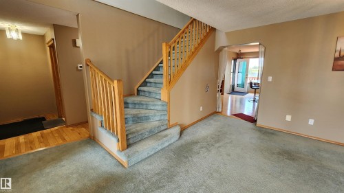 Central staircase with wood balustrade and carpeted treads - 2708 44A Avenue, Edmonton, AB 