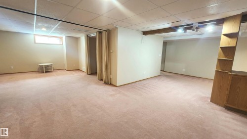 Expansive carpeted area with a drop ceiling and recessed lighting - 2708 44A Avenue, Edmonton, AB 