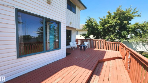 Spacious wood deck with perimeter railing and integrated steps - 2708 44A Avenue, Edmonton, AB 