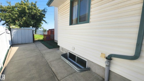Concrete walkway leading to a fenced backyard - 2708 44A Avenue, Edmonton, AB 