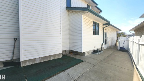 White vinyl siding exterior with dark trim and gutters - 2708 44A Avenue, Edmonton, AB 