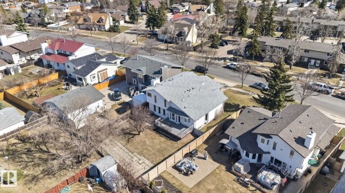 Property featuring a light-colored exterior with a dark shingle roof - 5612 Mcleod Road, Edmonton, AB 
