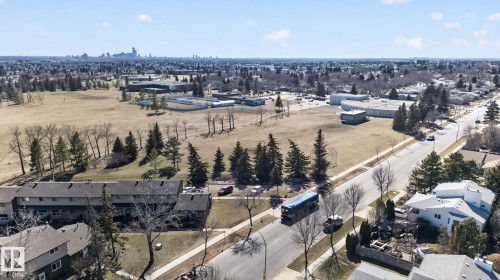 Aerial perspective showcasing the surrounding residential area with distant city skyline - 5612 Mcleod Road, Edmonton, AB 