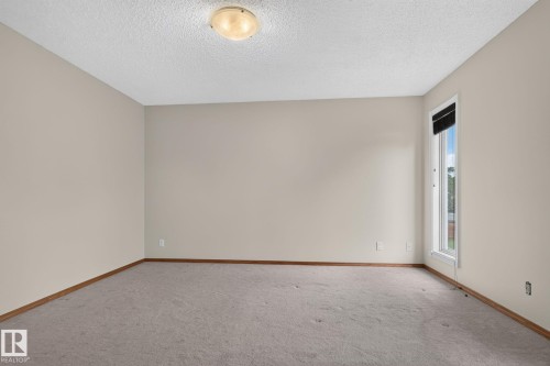 Neutral-toned walls complement plush carpeting and wood-finish baseboards - 5612 Mcleod Road, Edmonton, AB 