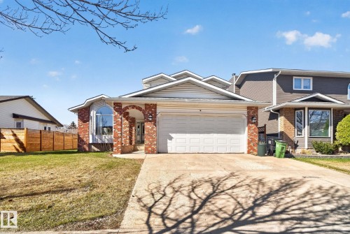 Two-story residence featuring a brick and siding exterior, an attached two-car garage, and a concrete driveway - 5612 Mcleod Road, Edmonton, AB 