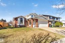 Brick and siding exterior featuring a prominent bay window - 5612 Mcleod Road, Edmonton, AB 