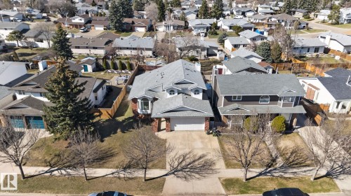 Two-story residence featuring a gray shingle roof and a brick facade accent - 5612 Mcleod Road, Edmonton, AB 