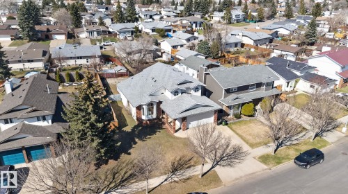 Traditional-style residence featuring a prominent front-facing bay window, brick detailing, and a multi-level roofline - 5612 Mcleod Road, Edmonton, AB 