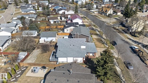 Property with a light gray shingled roof, white siding, and a wooden deck - 5612 Mcleod Road, Edmonton, AB 