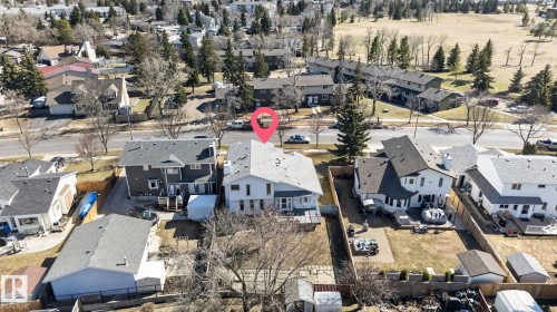 Aerial perspective showcasing a residential property with a multi-gabled roof and white exterior siding - 5612 Mcleod Road, Edmonton, AB 