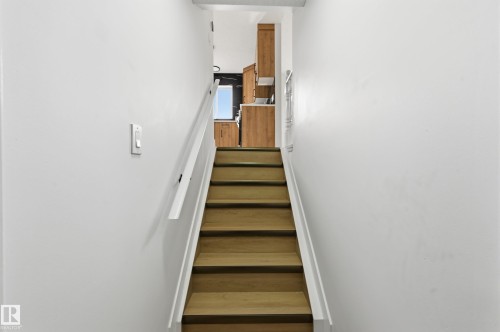 Hardwood stairs with white risers and handrails - 631 Jenner Cove Cove, Edmonton, AB 