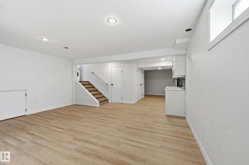 Open-concept room featuring wood-finish flooring, recessed lighting, and a window for natural light - 631 Jenner Cove Cove, Edmonton, AB 