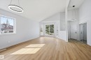 Vaulted ceilings featuring two modern circular pendant lights - 631 Jenner Cove Cove, Edmonton, AB 