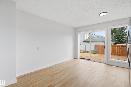 Bright interior with wood-finish flooring and white baseboards - 631 Jenner Cove Cove, Edmonton, AB 