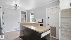 Kitchen island with a raised countertop and dark wood cabinetry - 