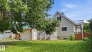 House exterior featuring light-colored siding and a metal roof - 10115 104 Street, Westlock, AB 
