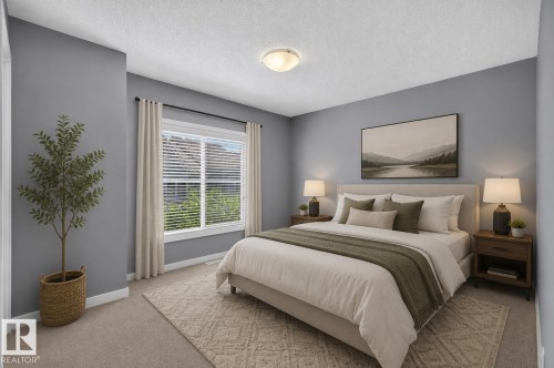 Spacious bedroom featuring light gray wall paint, a large window with blinds, and beige carpeting - 24 655 Watt Boulevard, Edmonton, AB 