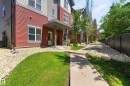 Modern multi-level building with red and grey siding - 24 655 Watt Boulevard, Edmonton, AB 