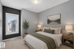 Carpeted bedroom featuring a window with white blinds, a contrasting accent wall, and a flush-mount ceiling light - 
