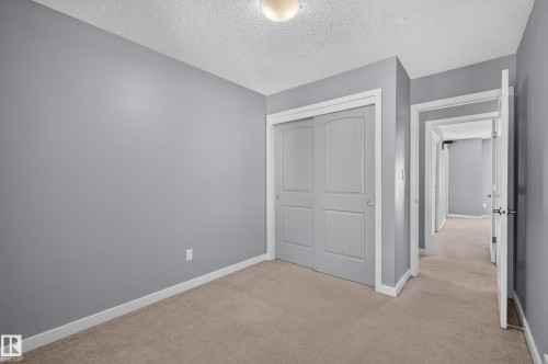 Room featuring neutral-toned carpet, light gray wall paint, and white trim - 24 655 Watt Boulevard, Edmonton, AB 