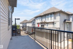Private balcony with concrete flooring and black metal railings - 