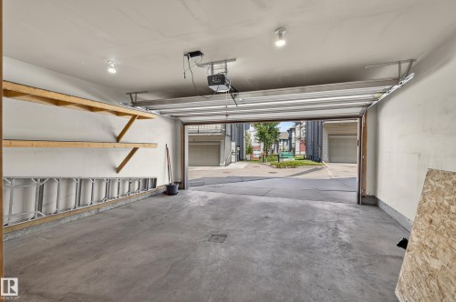 Attached garage with concrete flooring, built-in shelving, an automatic garage door opener, and recessed lighting - 24 655 Watt Boulevard, Edmonton, AB 