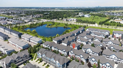 Aerial perspective showcasing a residential community with townhomes and detached properties - 24 655 Watt Boulevard, Edmonton, AB 