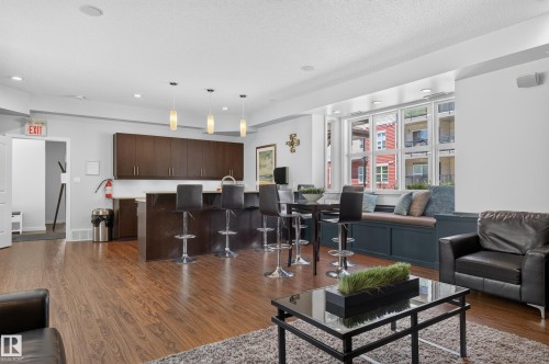 Open concept space featuring wood-finish flooring and a built-in window seat - 24 655 Watt Boulevard, Edmonton, AB 