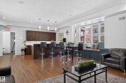 Open concept space featuring wood-finish flooring and a built-in window seat - 