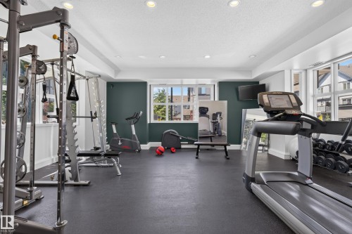 Dedicated fitness space featuring rubberized flooring, recessed lighting, and expansive windows - 24 655 Watt Boulevard, Edmonton, AB 