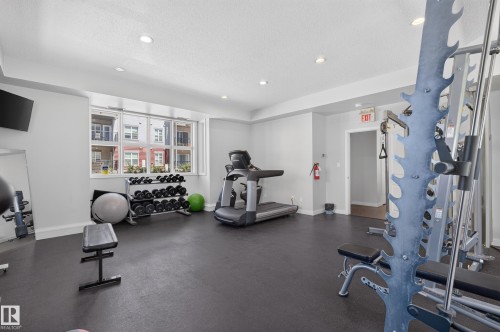 Dedicated fitness room featuring recessed lighting, a large multi-pane window, and durable dark flooring - 24 655 Watt Boulevard, Edmonton, AB 