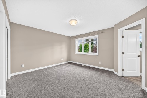 Spacious room featuring neutral painted walls, light grey carpeting, and white trim - 69 Tonewood Boulevard, Spruce Grove, AB - Indoor Photo Showing Other Room