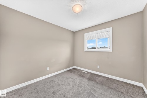 Neutral tone walls with white trim, a single window with blinds, and gray carpeting - 69 Tonewood Boulevard, Spruce Grove, AB - Indoor Photo Showing Other Room