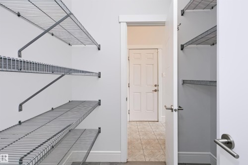 Open closet with wire shelving system, white interior walls, and grey baseboards - 1235 164 Street, Edmonton, AB 