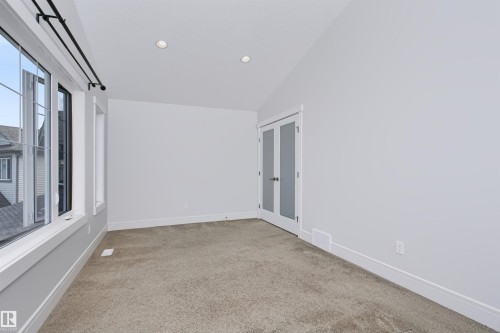 Bright room featuring white walls, recessed ceiling lighting, and light-colored carpeting - 1235 164 Street, Edmonton, AB 