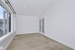 Bright room featuring white walls, recessed ceiling lighting, and light-colored carpeting - 