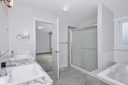 Dual vanity with white undermount sinks and a marble-patterned countertop - 1235 164 Street, Edmonton, AB 