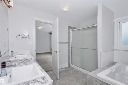 Dual vanity with white undermount sinks and a marble-patterned countertop - 