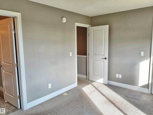 Neutral tone painted walls complement white trim and panel doors - 23 1508 105 Street, Edmonton, AB 