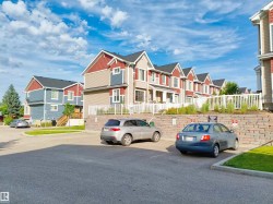 Row of multi-story residences featuring pitched roofs and varied siding textures - 