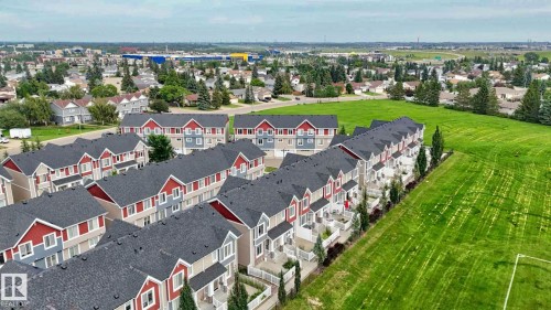 Contemporary townhome complex featuring multi-toned siding and dark shingle roofs - #23 1508 105 St Nw, Edmonton, AB - Outdoor With View