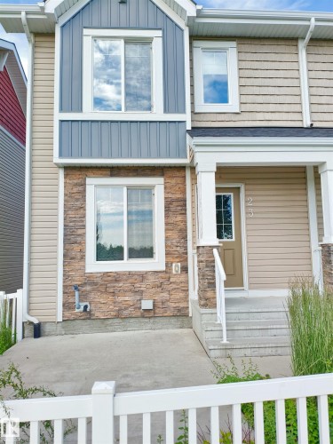 Multi-level facade featuring stone veneer accents, vertical board and batten siding, and horizontal siding - 23 1508 105 Street, Edmonton, AB 